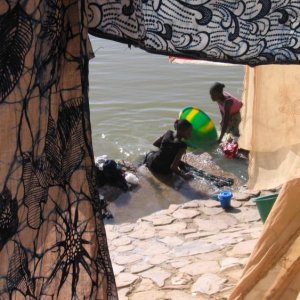 Young women washing clothes for a living, in the Niger River